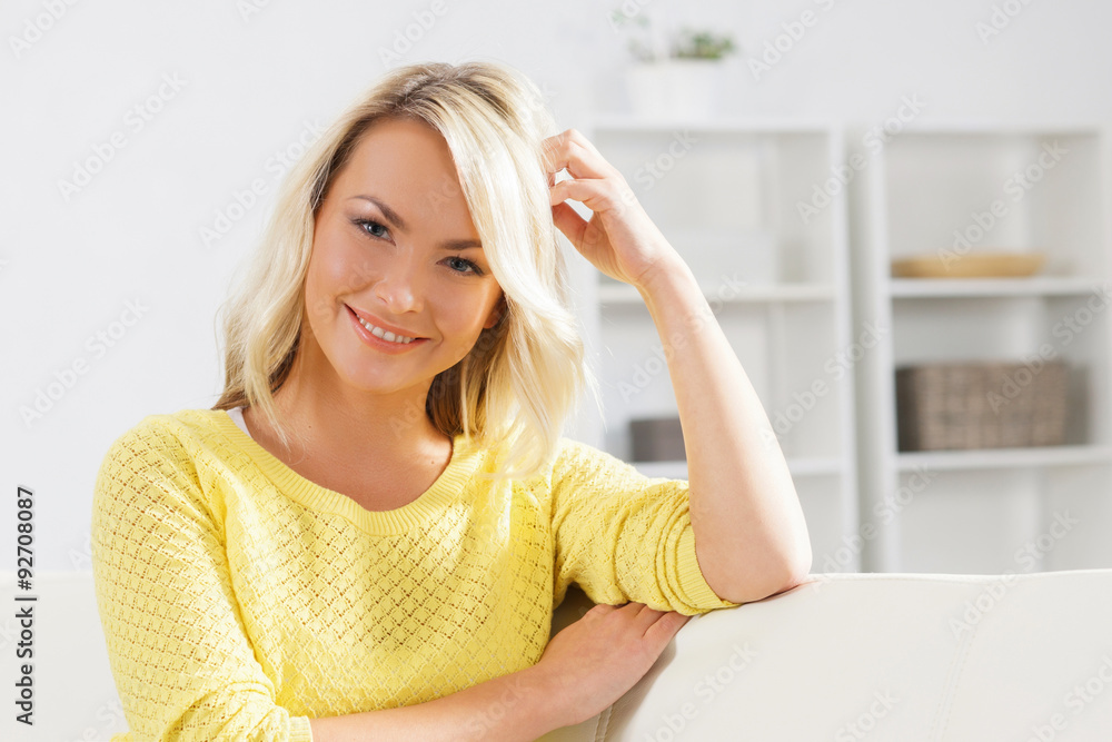 Young and happy woman resting on sofa at home Young and happy woman resting on sofa at home
