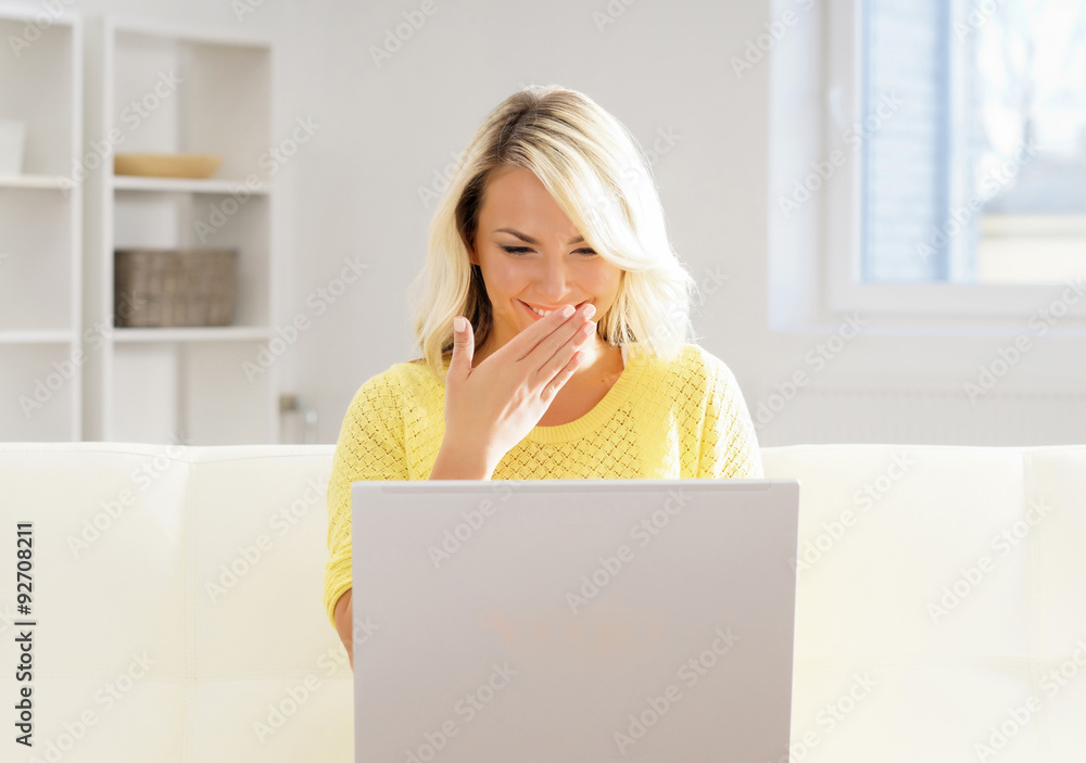 Beautiful blond girl with a notebook pc at home Beautiful blond girl with a notebook pc at home
