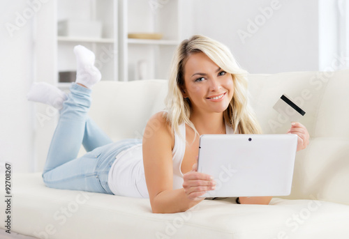 Free Download Attractive blond woman with a credit card and a tablet computer. - GFXLoad