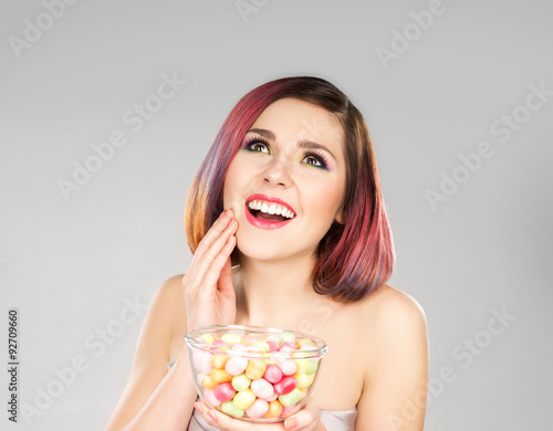 Attractive girl in dress with a bowl of sweets.