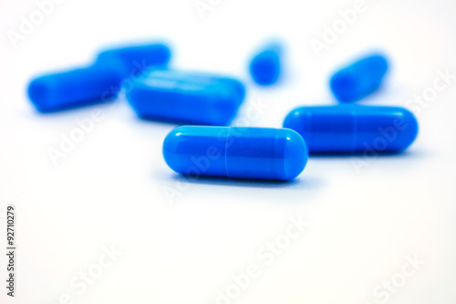 blue capsules on a white background