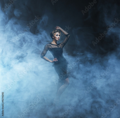 Young and emotional woman in fashion dress over glamour backgrou