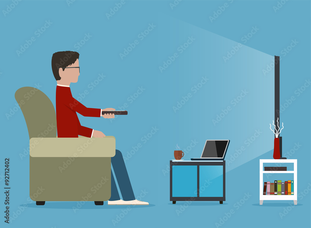 Man watches TV on sofa, before journal table Man watches TV on sofa, before journal table
