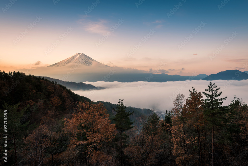 Mount Fuji enshrouded in clouds with clear sky from lake kawaguchi, Yamanashi, Japan Mount Fuji enshrouded in clouds with clear sky from lake kawaguchi, Yamanashi, Japan