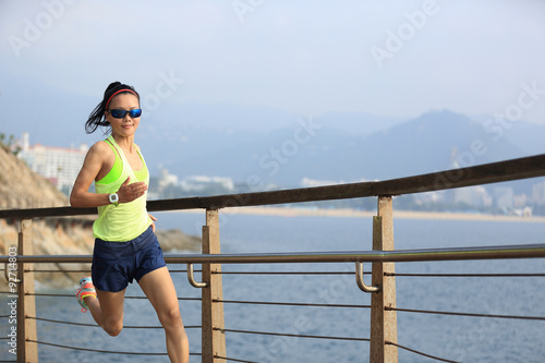 Fototapeta Naklejka Na Ścianę i Meble -  fitness sports woman running on wooden boardwalk seaside