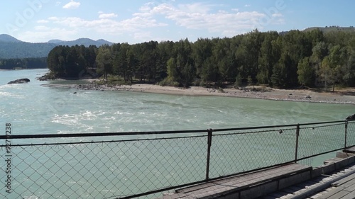 Panoramic view from the suspension bridge over the river Katun in the summer and the hotel 