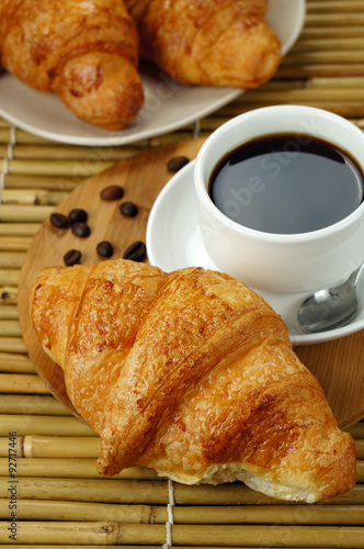 Croissant with ready for breakfast on rustic wooden table