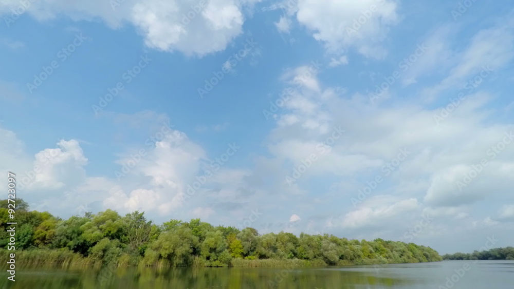 White Fluffy Clouds over the River. Timelapse. 4K. White Fluffy Clouds over the River. Timelapse. 4K.