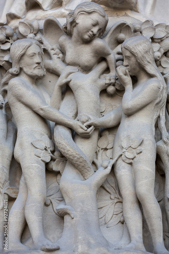 Paris - West facade of Notre Dame Cathedral. The Virgin Mary portal .Scenes from Genesis.Eve offers the forbidden fruit to Adam.