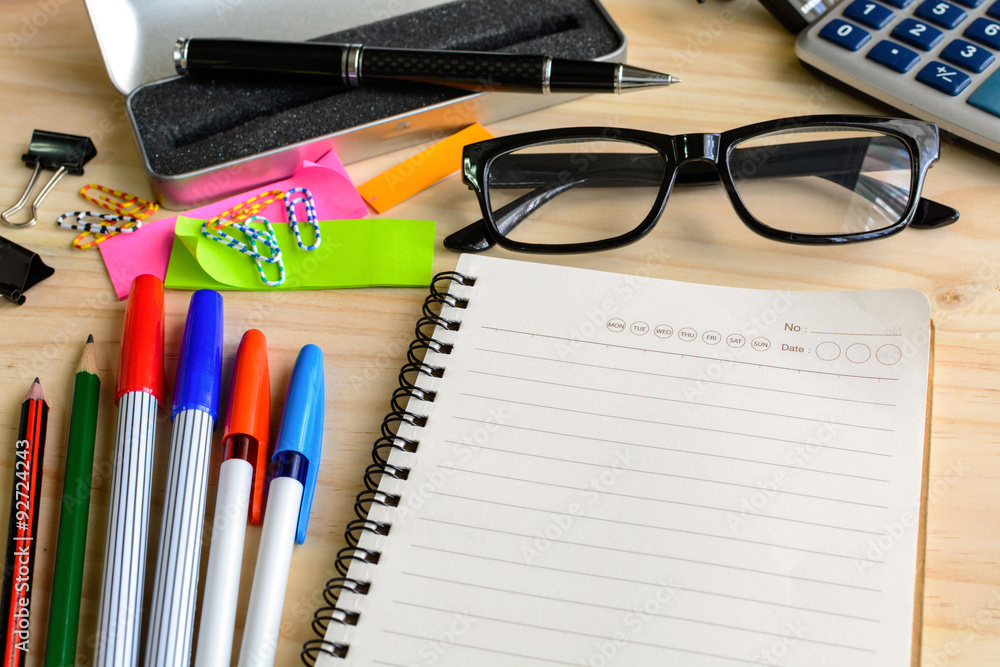 Blank notebook with office supply on desk Blank notebook with office supply on desk