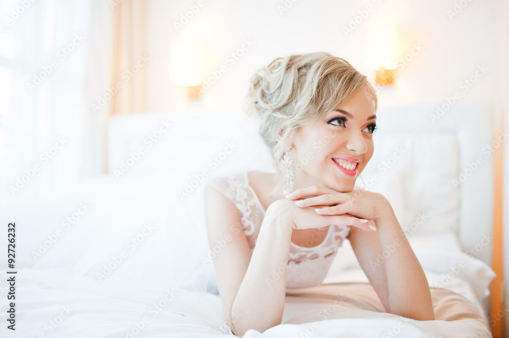 gentle blonde bride on couch tenderly posed gentle blonde bride on couch tenderly posed