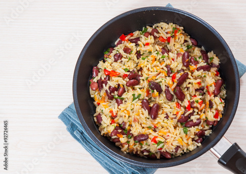 Rice with red beans and vegetables in a frying pan