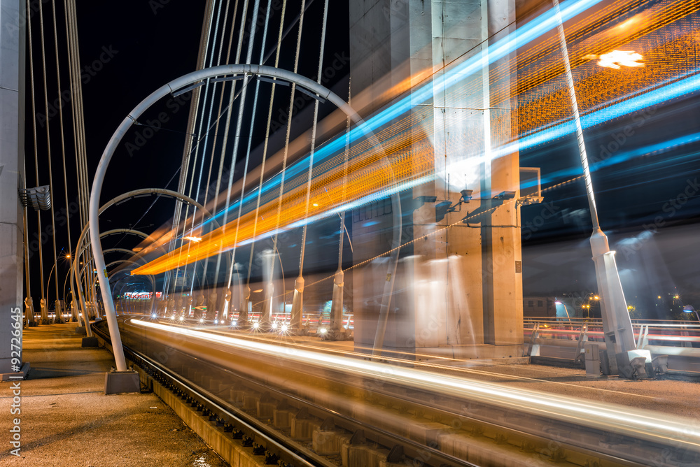 Fototapeta premium Tram in motion blur on a suspended bridge
