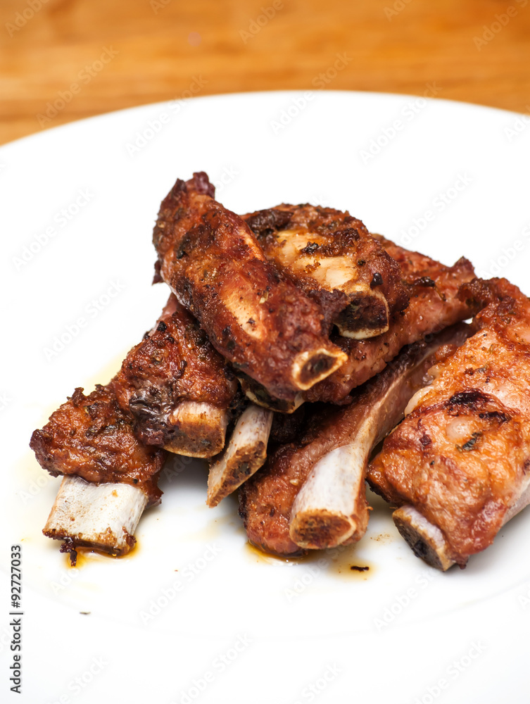 Roasted pork ribs on a white plate Roasted pork ribs on a white plate