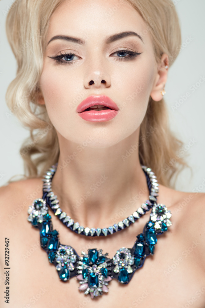 Beautiful portrait of a woman with fashion makeup and necklace