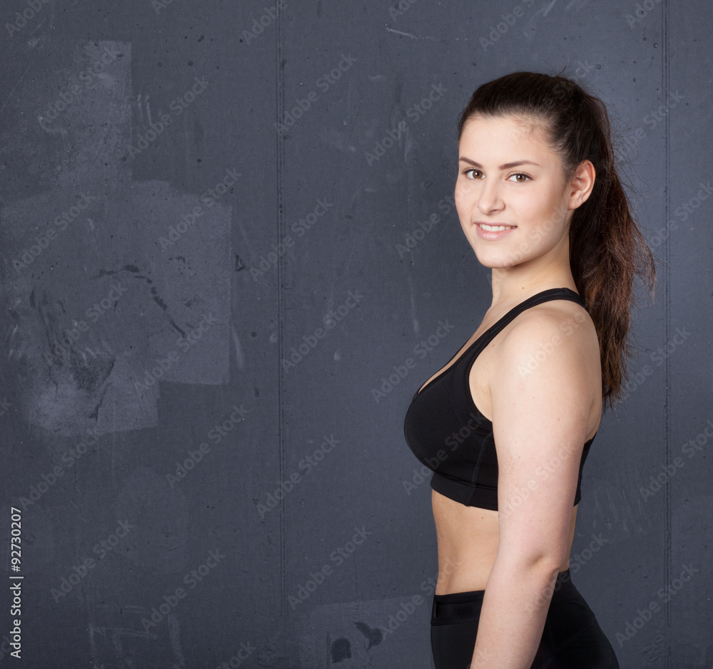 Beautiful woman in sport dress looking at camera Beautiful woman in sport dress looking at camera