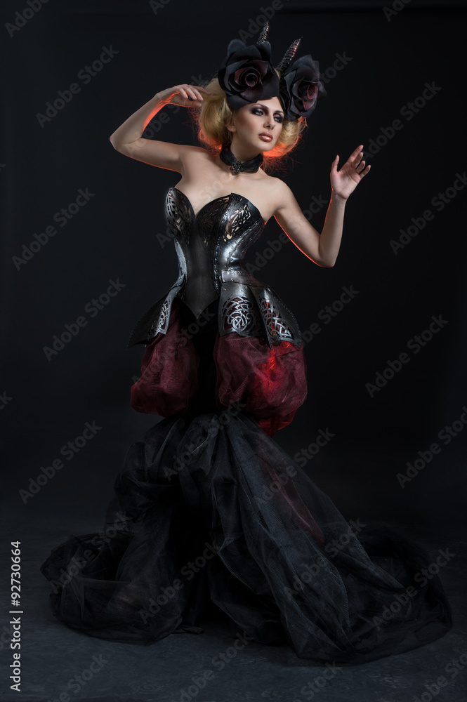 Portrait of beautiful blond woman in dark sexy corset in studio Portrait of beautiful blond woman in dark sexy corset in studio