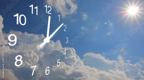 Clock and clouds, timelapse. Sun shines among the clouds