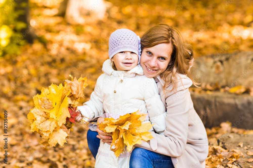 Mother and daughter in an autumn park Mother and daughter in an autumn park