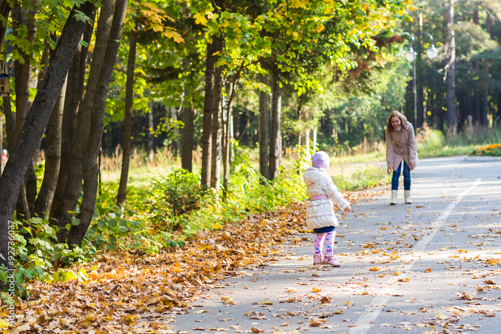 Little girl and her mother playing in the park Little girl and her mother playing in the park