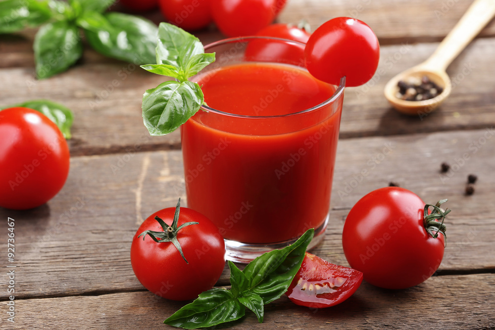 Glass of tomato juice on wooden table, closeup Glass of tomato juice on wooden table, closeup