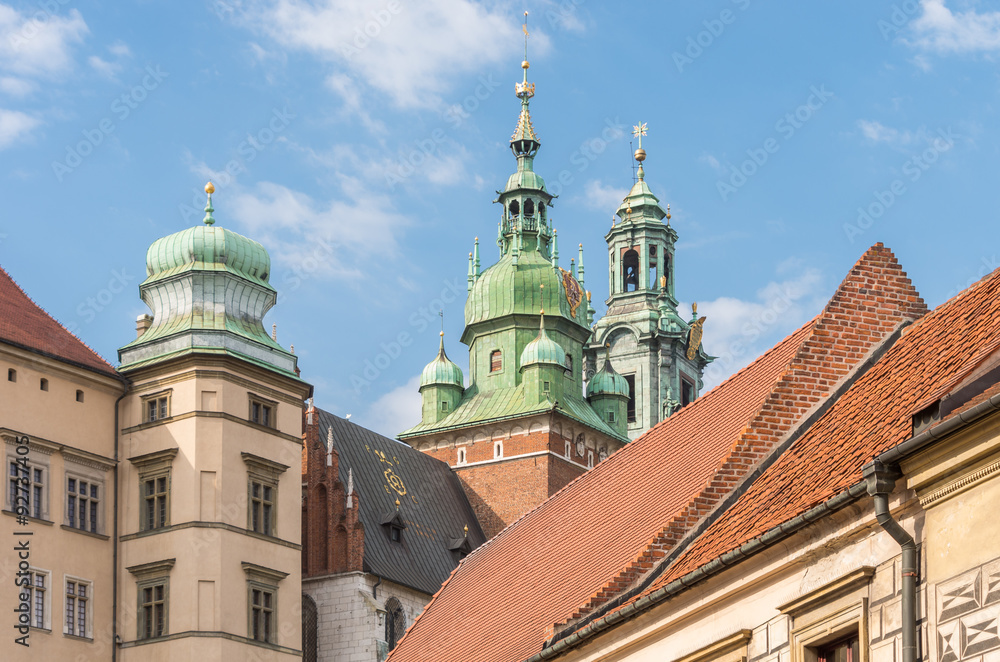 Krakow, Poland, Wawel Hill with royal castle and cathedral seen from Kanonicza street over red roofs
