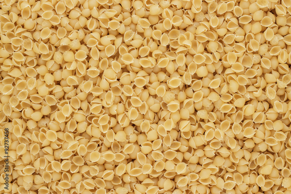 dry uncooked conchiglie pasta texture background