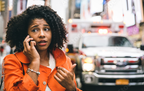 afro american woman calling 911 in New york city. concept about car accidents and emergency