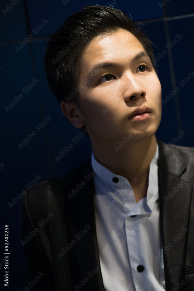 Stylish portrait of chinese elegant model near wall store in evening Stylish portrait of chinese elegant model near wall store in evening