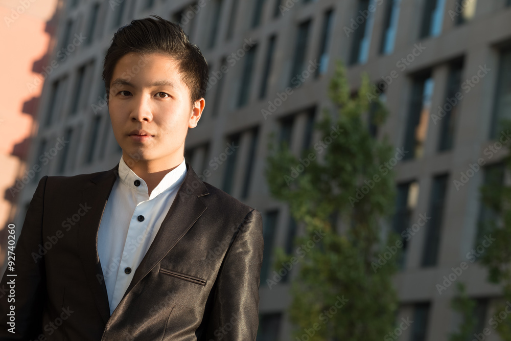 Portrait of chinese elegant businessman near building Portrait of chinese elegant businessman near building
