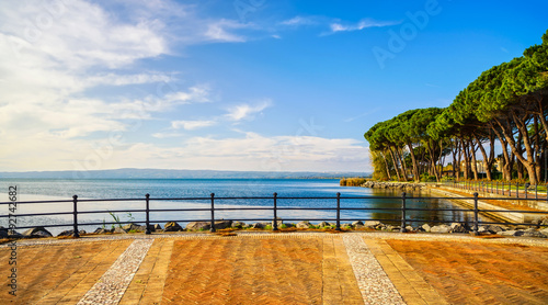 Fototapeta Naklejka Na Ścianę i Meble -  Terrace, promenade and pine trees in Bolsena lake, Italy.