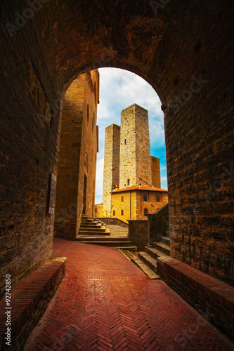 San Gimignano sunset from a tunnel, towers in central Erbe squar photo