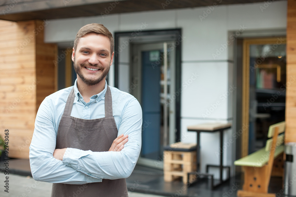 Attractive male owner of cafeteria is waiting for customers Attractive male owner of cafeteria is waiting for customers