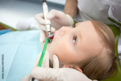 Cheerful male child is visiting dental doctor
