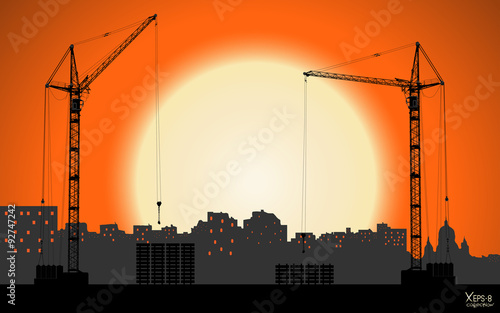 High detailed vector hoisting cranes building the town on sunset background. Vector illustration