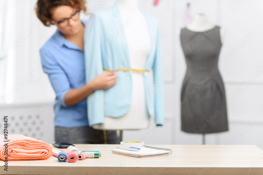 Fototapeta premium Pleasant designer making clothes