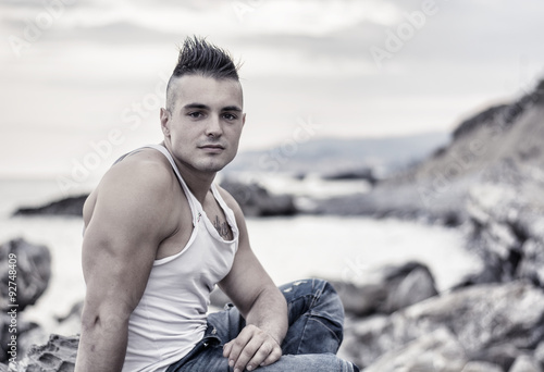 Handsome Athletic Man Looking Up Against Sky