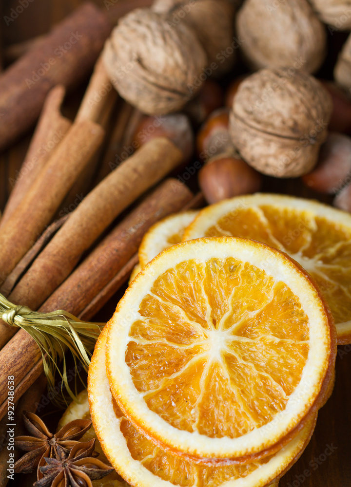 cinnamon sticks, cloves, anise stars,walnuts and slices of dried citrus cinnamon sticks, cloves, anise stars,walnuts and slices of dried citrus
