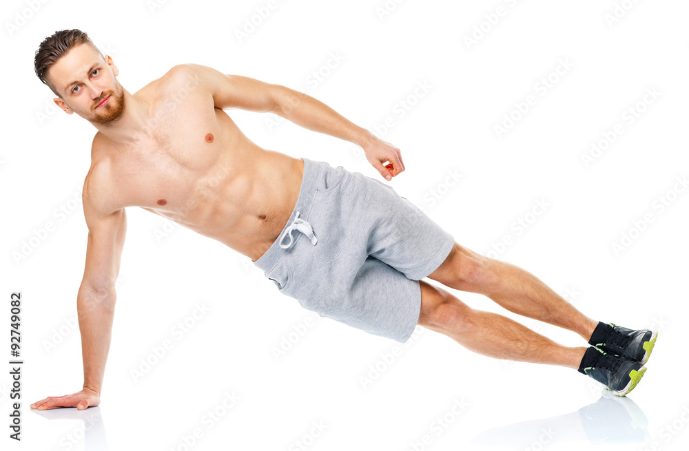 Sport attractive man doing fitness exercises on the white Sport attractive man doing fitness exercises on the white