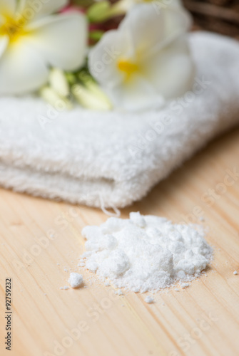 Herbal salt scrub on wood background