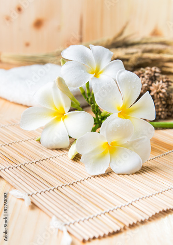 white Plumeria on wood bamboo mat.