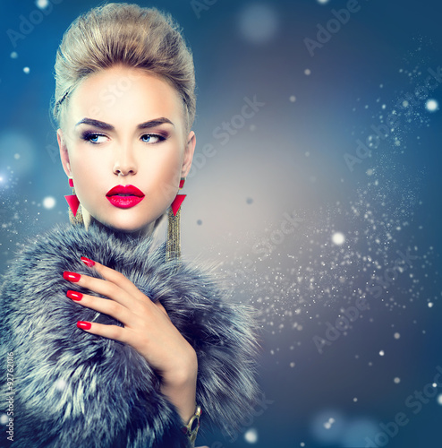 Beauty fashion model girl in blue fox fur coat
