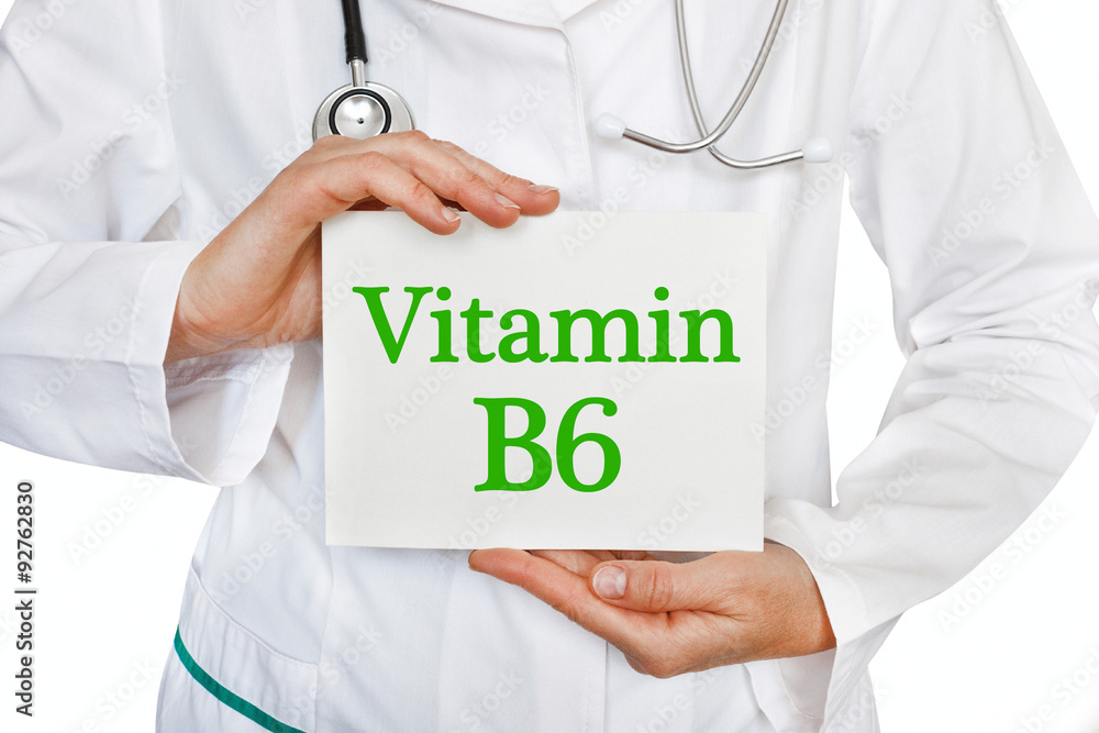 The female doctor, with the plate Vitamin B6, medical concept The female doctor, with the plate Vitamin B6, medical concept