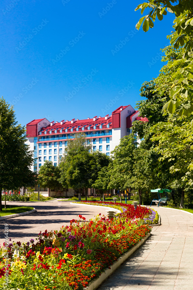 Park with blooming flowers with multistorey building Park with blooming flowers with multistorey building