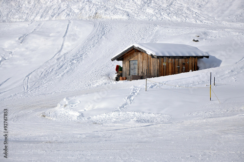 Snow-covered old wooden hut in the Austrian Alps #92767853