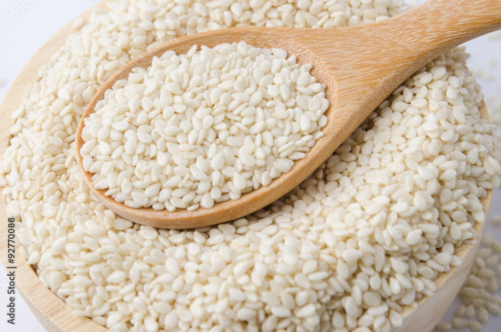 sesame seeds with wooden spoon sesame seeds with wooden spoon