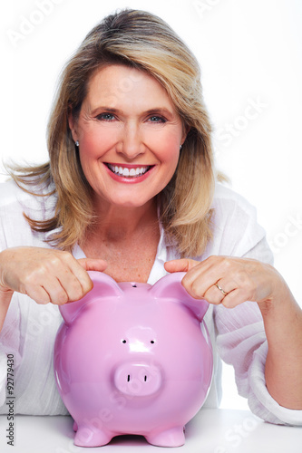 Elderly woman with piggy bank.