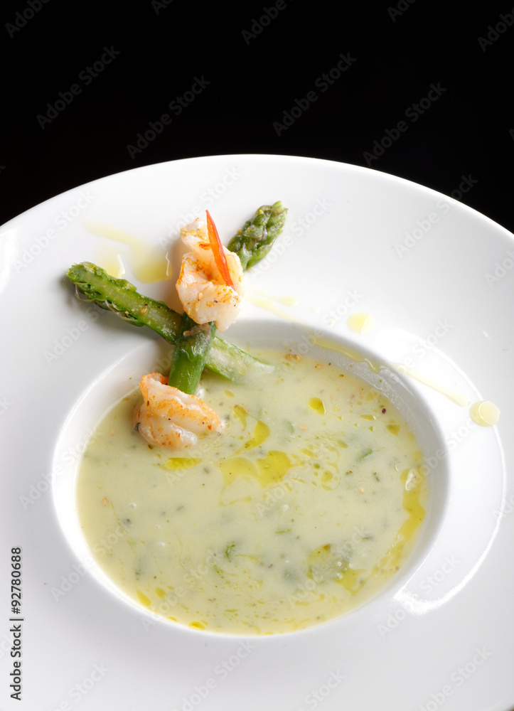 Delicious cream soup with asparagus and shrimp. Selective focus Delicious cream soup with asparagus and shrimp. Selective focus
