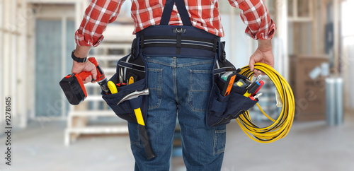 Electrician man with drill and wire cable.