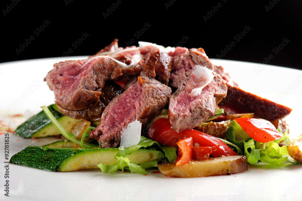 Grilled sliced roast beef on potato and salad Grilled sliced roast beef on potato and salad
